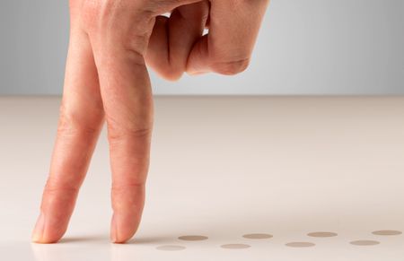 Female fingers walking with dots behind them