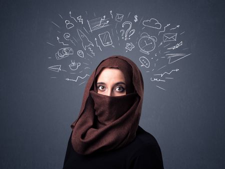 Young muslim woman wearing niqab with mixed white drawings above her head