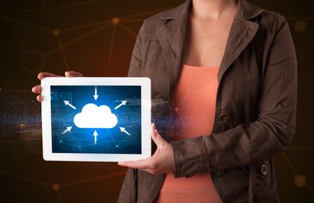 Casual young woman holding tablet with cloud concept