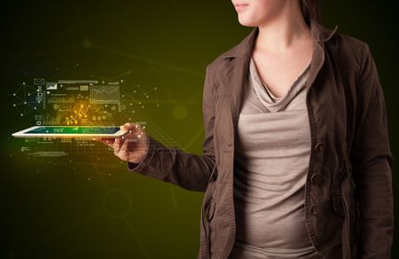 Casual young woman holding tablet with strategy and business related graphics