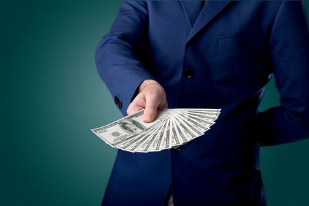 Young businessman holding large amount of bills 