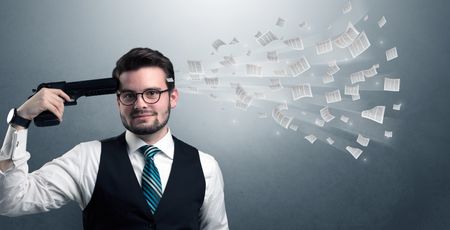 Handsome businessman shoots his head with gun and documents coming out from his head