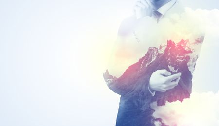 businessman-standing-thinking-snowy-mountain-graphic-618010400 Businessman standing and thinking with snowy mountain graphic