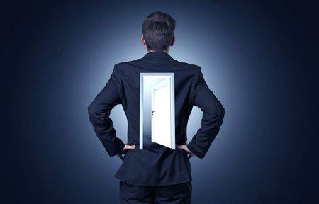 Young businessman standing and thinking with an open door on his back