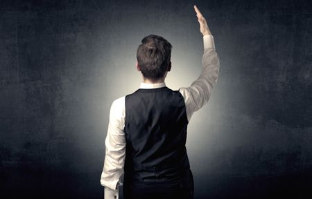 Young businessman standing and thinking alone