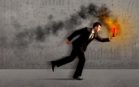 Running business man in a hurry with fire laptop concept