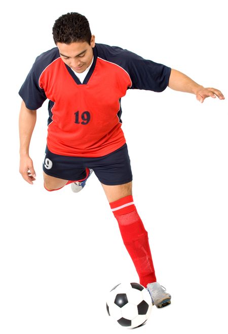 footballer about to kick the ball isolated over a white background