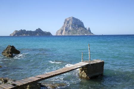 Pier at Hort Cove and Beach with Vedra Island; Ibiza, Spain