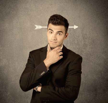 A confused young business guy giving thumbs up with a drawn arrow going through his head concept