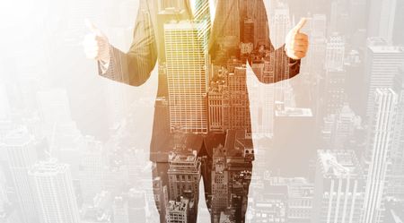 Business man with warm color overlay of city background texture