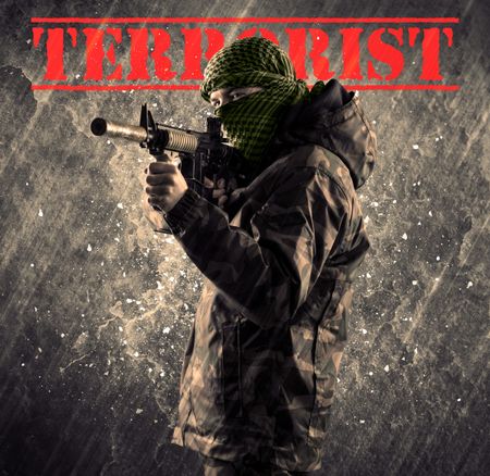 Portrait of dangerous masked and armed man with terrorist sign on grungy background