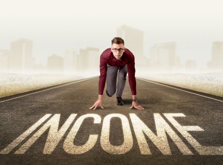 Young determined businessman kneeling before income sign