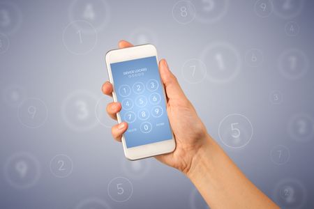 Female fingers touching smartphone with locked device requiring passcode