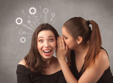 Two girlfriends in elegant black dress sharing secrets with each other concept with drawn rack cog wheels and spiral lines on the wall background.