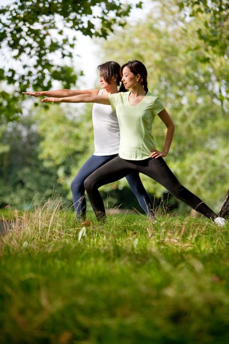 Beautiful women stretching at the park - fitness concepts