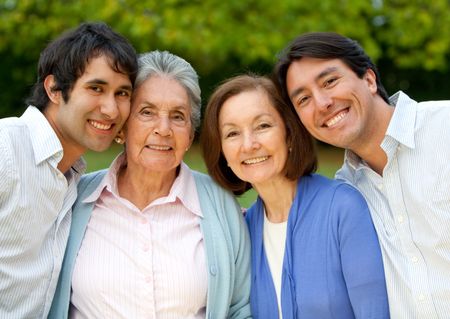 Family portrait of a grandmother, her daughter and grandsons smiling