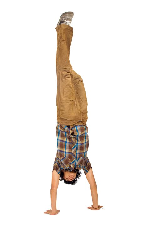 casual guy doing the handstand isolated over a white background