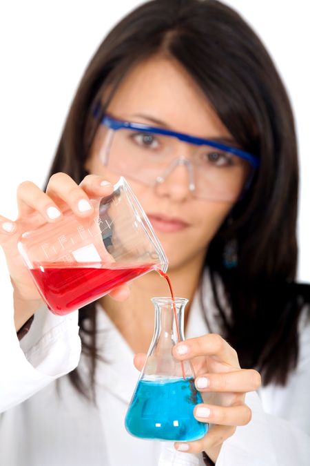 female chemist mixing liquids in test tubes