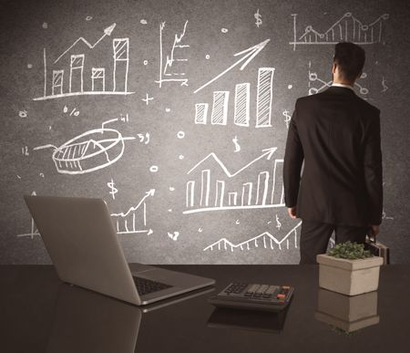 A young marketing office worker drawing pie chart and graph on wall at financial meeting concept