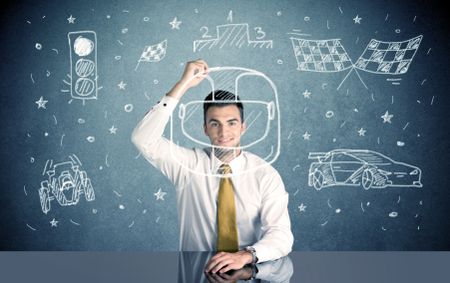 A happy businessman sitting at desk and drawing race car, flag, helmet around himself with a white chalk concept