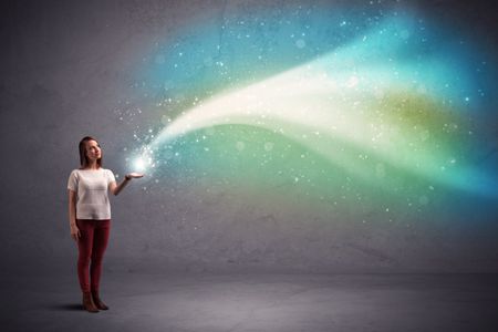 Caucasian woman holding blue, white, green coloured stria of light