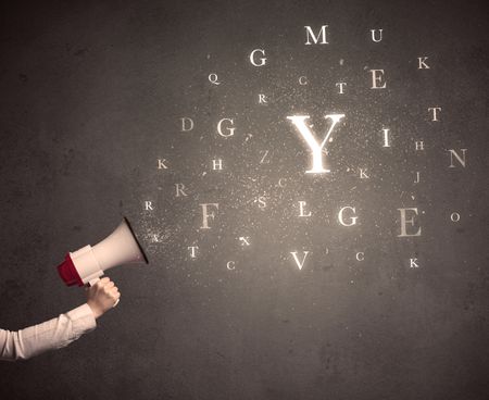 Caucasian arm holding megaphone with letter cloud