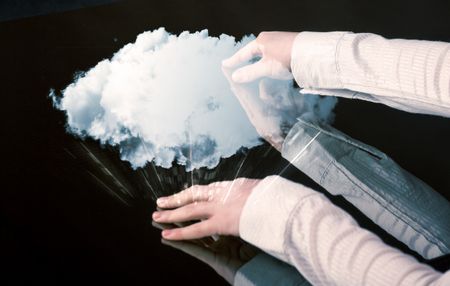 Male hands touching interactive table with a white cloud on it 