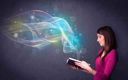 Casual young woman holding book with rainbow waves flying out of it