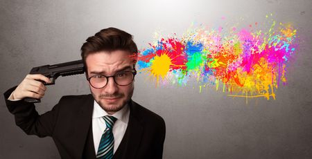 Man shoots his head with gun and colorful splotch are coming out from his head