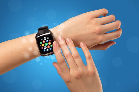 Naked female hand with smartwatch and with application icons on it