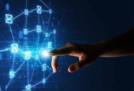 female-finger-touching-beam-light-surrounded-626460245 Female finger touching a beam of light surrounded by a blue graphic with envelopes