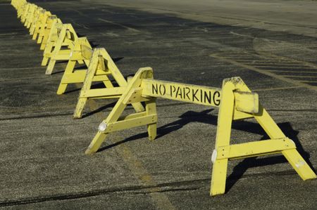 Row of "No Parking" barriers across parking lot