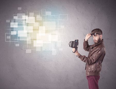 A funny stylish hipster guy capturing bright moments and glowing square pictures with a vintage photo camera illustration concept