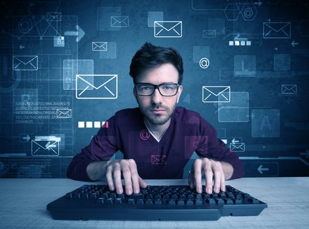 A talented young hacker hacking email address passwords concept with keyboard on desk and illustrated letters in the background