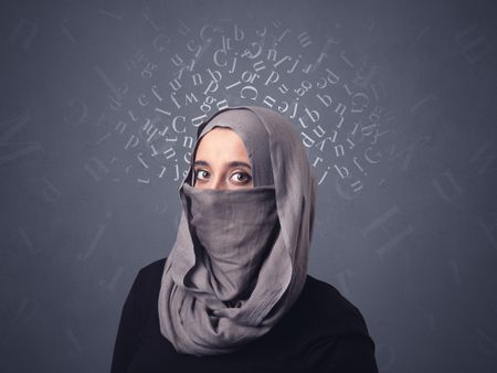 Young muslim woman wearing niqab with white alphabet letters above her head