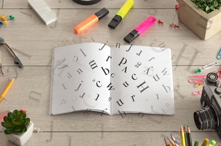 Open notebook on the floor with office instruments nearby and letters on it