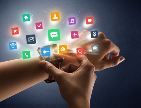 Naked female hand with smartwatch and  application labels around and dark background