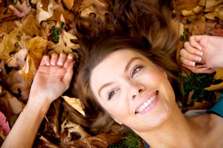 autumn girl portrait smiling and relaxing on the floor