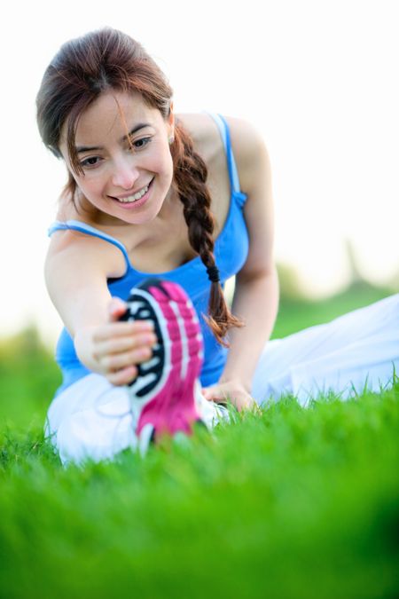 Beautiful woman stretching at the park - fitness concepts