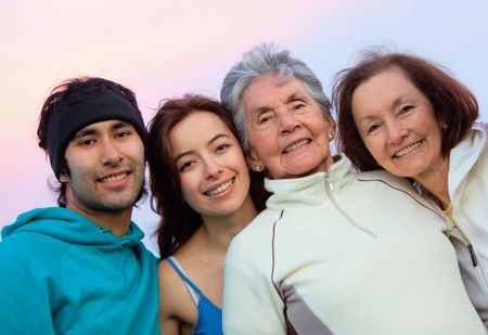 Family portrait of a grandmother, her daughter and grandchildren smiling