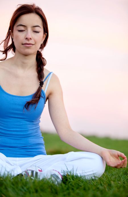 Young woman doing yoga exercises outdoors - fitness concepts