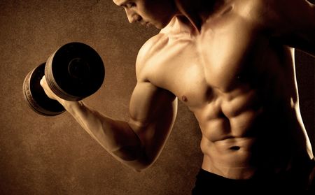 Muscular fit bodybuilder athlete lifting weight on grungy background