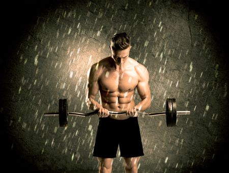 A handsome young body builder weightlifting while showing his muscular upper body in the rain concept