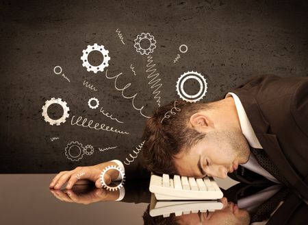 Falling apart illustration concept with cranks, cog wheels springing from a fed up and tired businessman's head resting on laptop keyboard