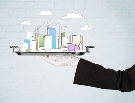 Serving a city concept with close up of waiter hand in gloves holding silver plate in front of grey brick wall