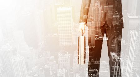 Business man with warm color overlay of city background texture