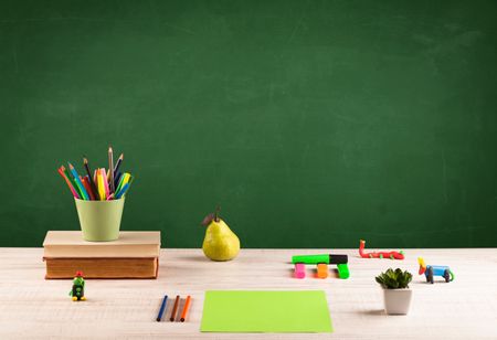 Back to school concepty with clear blackboard background, desk, items