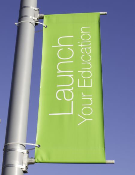 Motivational banner on campus of community college: Launch Your Education