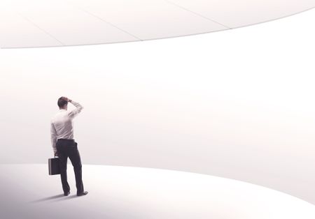 Young sales business person in elegant suit standing with his back in empty white space background with curved lines concept