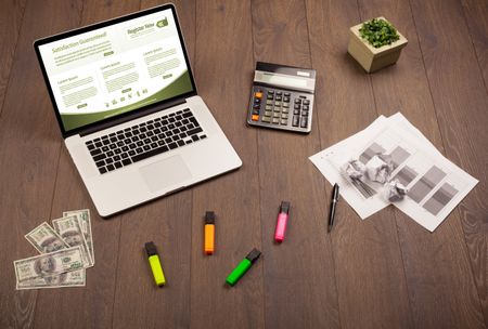 Business wooden table with notebook computer and office accessories